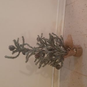 Artificial Christmas tree with snow and pinecones table top